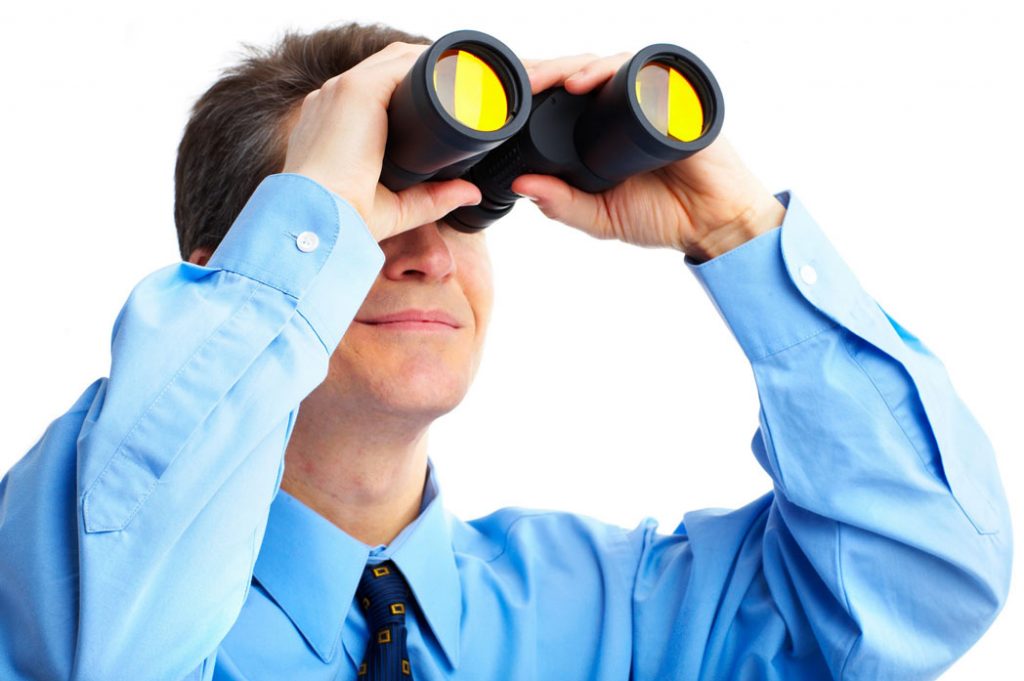 Business man using binoculars